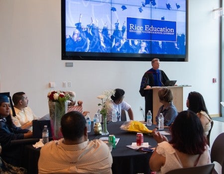 Rob Bruce speaks at the 2025 Rice Education graduation ceremony.